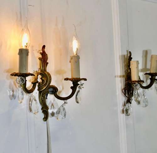 A pair of French Brass Twin Wall Lights The lights are in the classical style