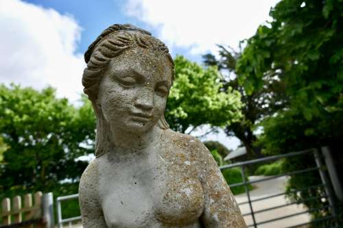 Old Weathered Statue of the Goddess Tyche Holding a Snake