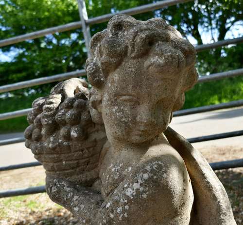 Pair of Old Weathered Classical Flower Children Statues
