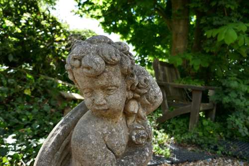 Pair of Old Weathered Classical Flower Children Statues
