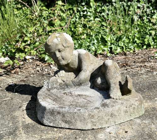 Weathered Garden Bird Bath with a Small Child