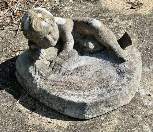 Weathered Garden Bird Bath with a Small Child