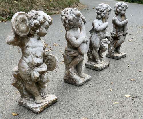 A Set of 4 Weather Worn Cherub Statues with Instruments