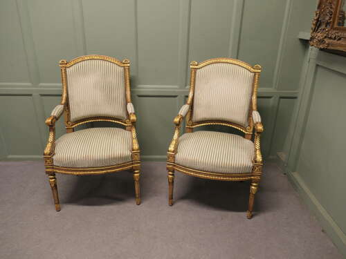 A  Pair of French Regency Style Open Arm Chairs