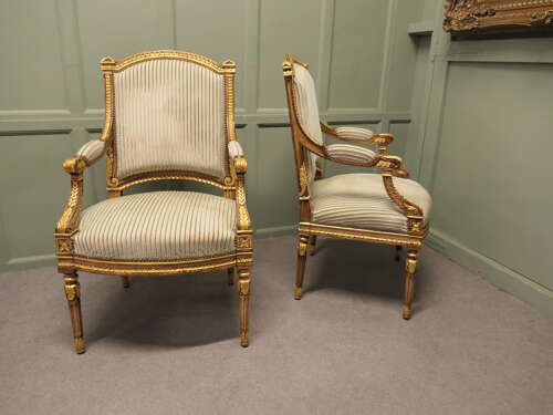 A Pair of French Regency Style Open Arm Chairs