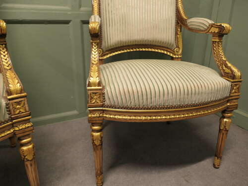 A Pair of French Regency Style Open Arm Chairs