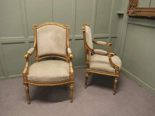 A Pair of French Regency Style Open Arm Chairs