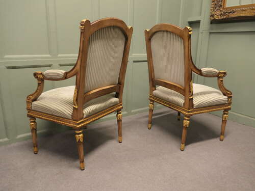 A Pair of French Regency Style Open Arm Chairs