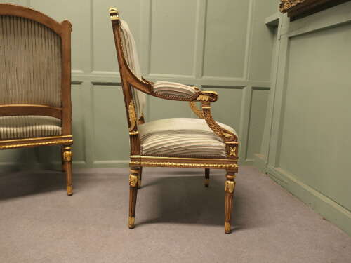 A Pair of French Regency Style Open Arm Chairs
