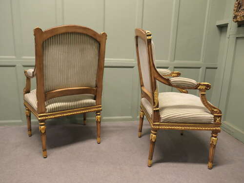 A Pair of French Regency Style Open Arm Chairs