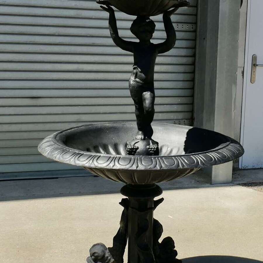 Black Cast Iron Fountain with Cherub Boy  A good piece in a classical style with dolphins
