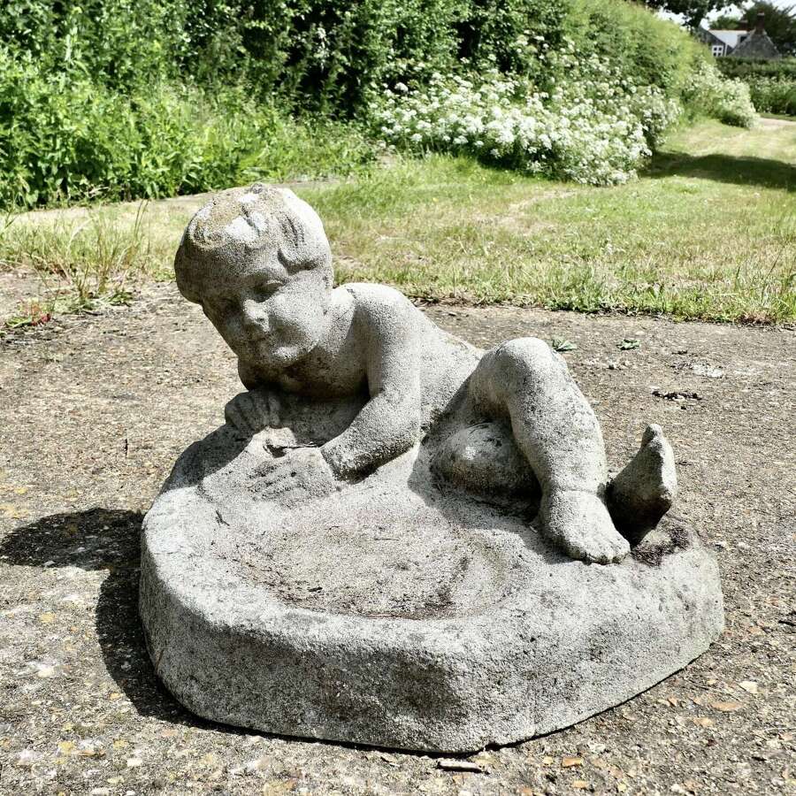 Garden Bird Bath with a Small Child Feeding the Birds   A well Weathered Garden Bird Bath