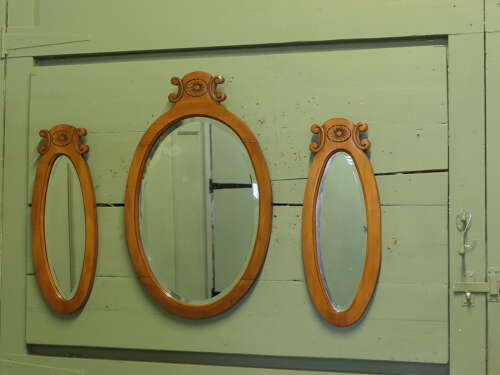 A Trio of Oval Satin Walnut Wall  Mirrors  The largest mirror is set off