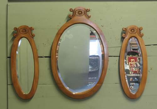 A Trio of Oval Satin Walnut Wall  Mirrors  The largest mirror is set off