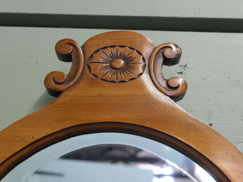 A Trio of Oval Satin Walnut Wall  Mirrors  The largest mirror is set off