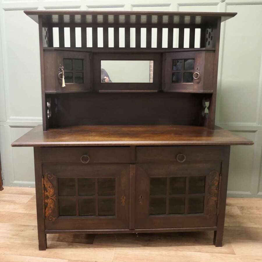 Arts & Crafts Oak Sideboard by Leonard Wyburd for Liberty & Co.  This piece is being offer