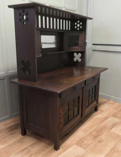 Arts & Crafts Oak Sideboard by Leonard Wyburd for Liberty & Co. This piece is being offer