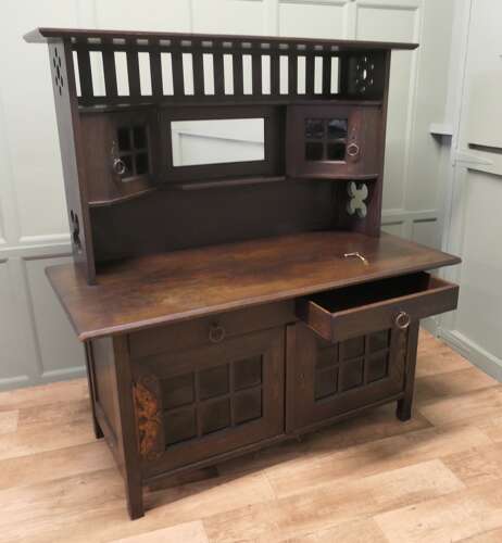 Arts & Crafts Oak Sideboard by Leonard Wyburd for Liberty & Co. This piece is being offer