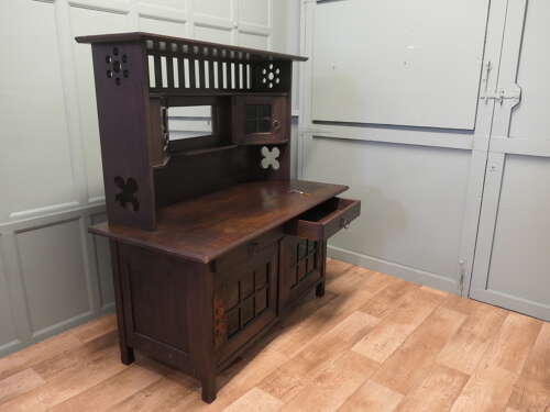 Arts & Crafts Oak Sideboard by Leonard Wyburd for Liberty & Co. This piece is being offer